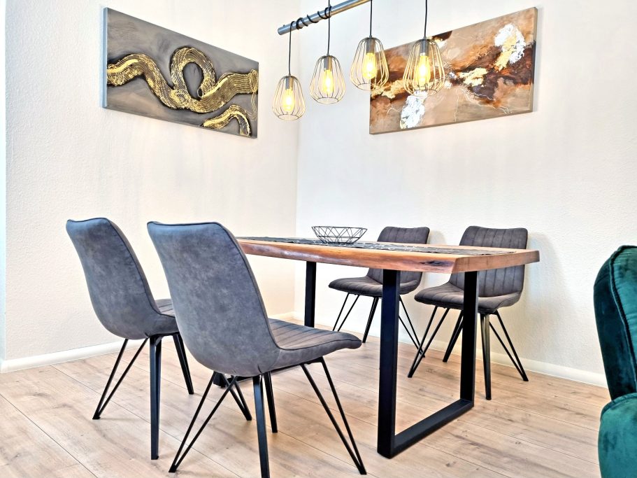 Essbereich Moderner Essbereich mit Holztisch, grauen Stühlen und stilvollen Pendelleuchten.